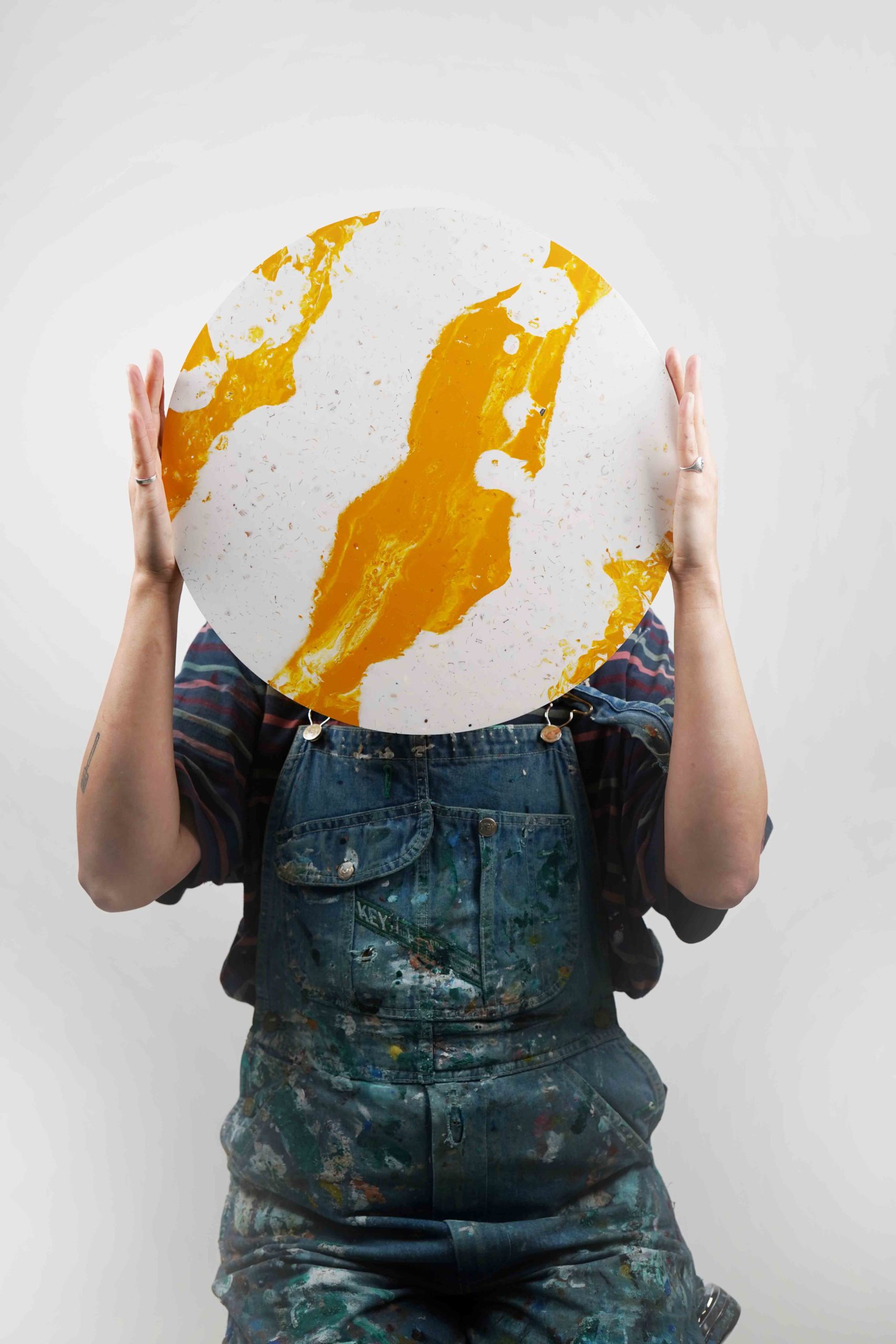 a person holding a tabletop over their face